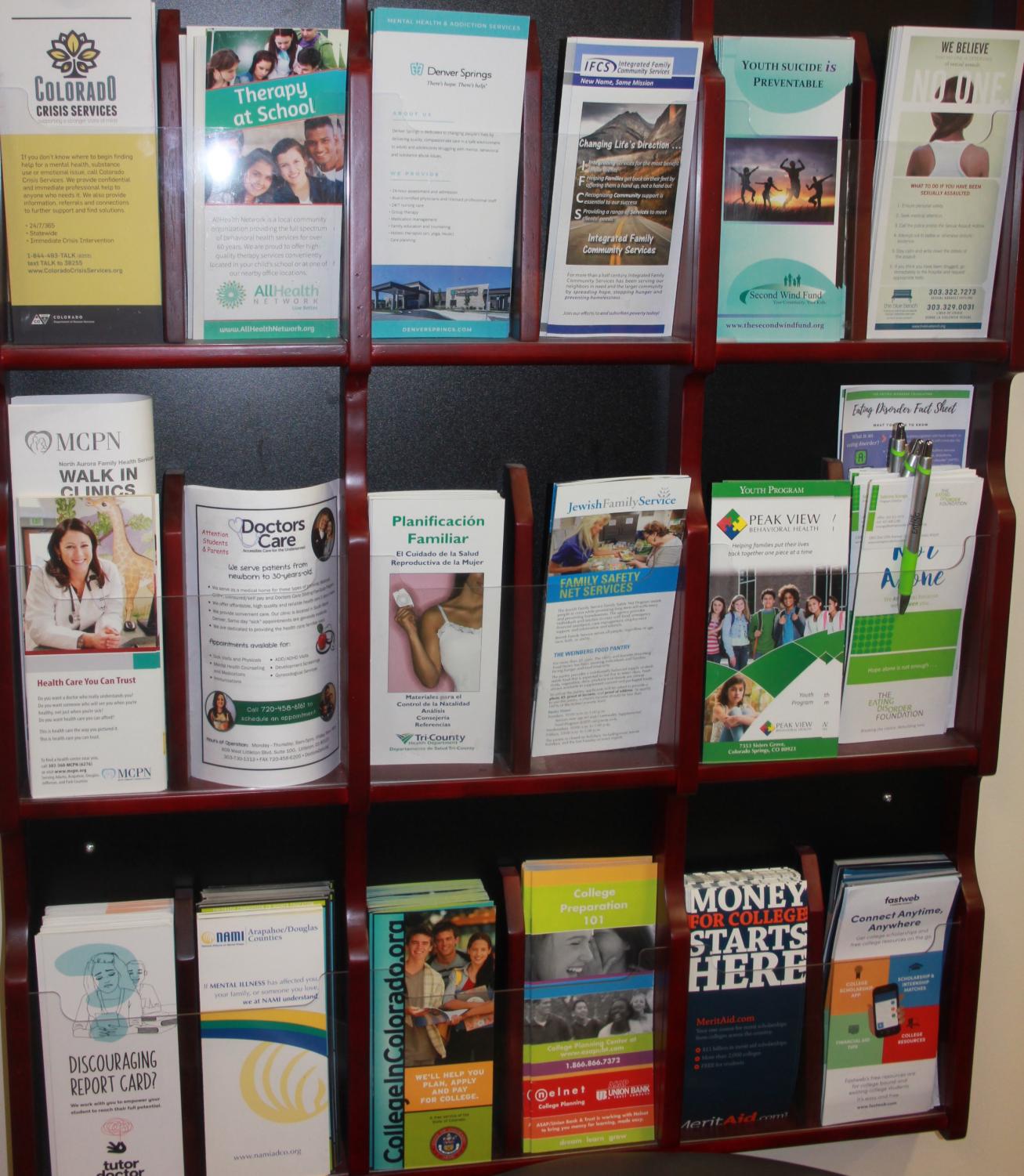 Information for students to get help and support are on a wall in the counseling office.