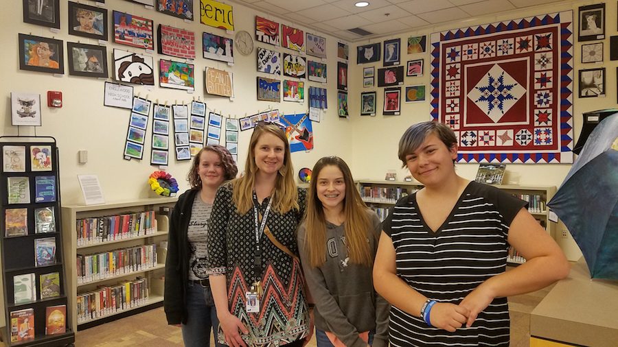 Emily Winthrop poses with students at the district art show
