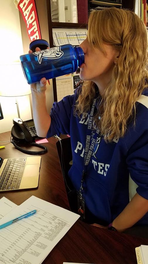 Counselor drinking from a water bottle