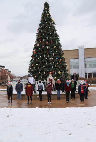  Carol of the bells Choir stands in front of the Englewood holiday tree.