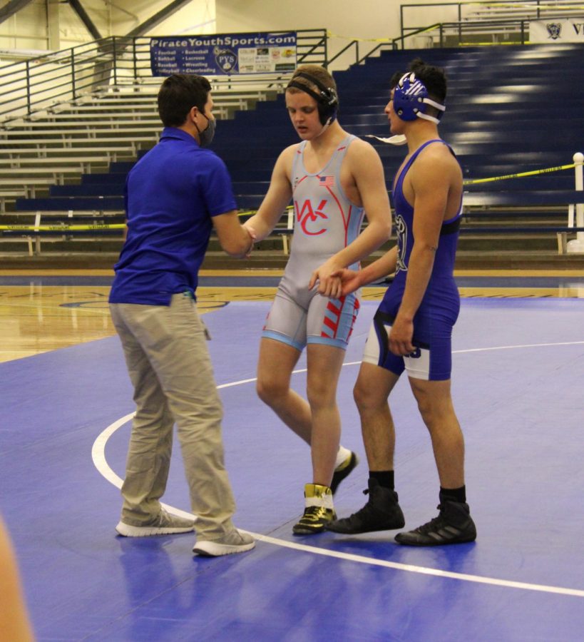 Coach Moreno (l) congratulates Asher Morelock (center) on the match with Joey Mora (r). Mora got the win. 