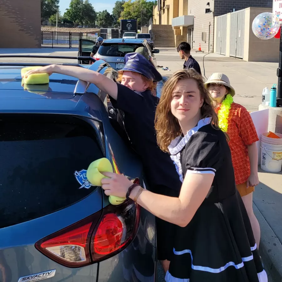 Students clean a car during their car wash event