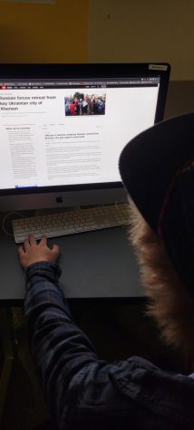 A student in social studies class looks up information on the war in Ukraine. Following international news is often hard for high school students. 