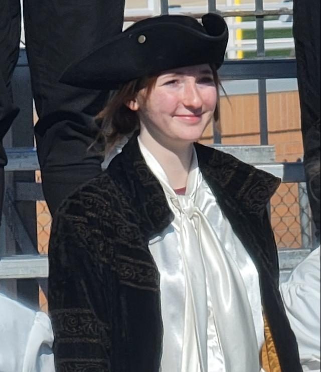 Reagan Scheminske celebrates with the band after the performance at state