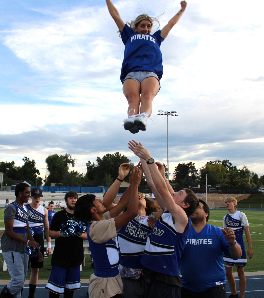 Boys dress as cheerleaders and the girls play football during the annual Powderpuff game. Brooklyn McCann trusts the Powderpuff team to catch her after she jumps off the top of a cradle. 