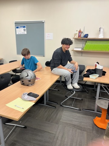 Pirate football players get fitted with their new helmets. Sophomore Ray Morales (r) got his head scanned to ensure the helmet fits snug. 