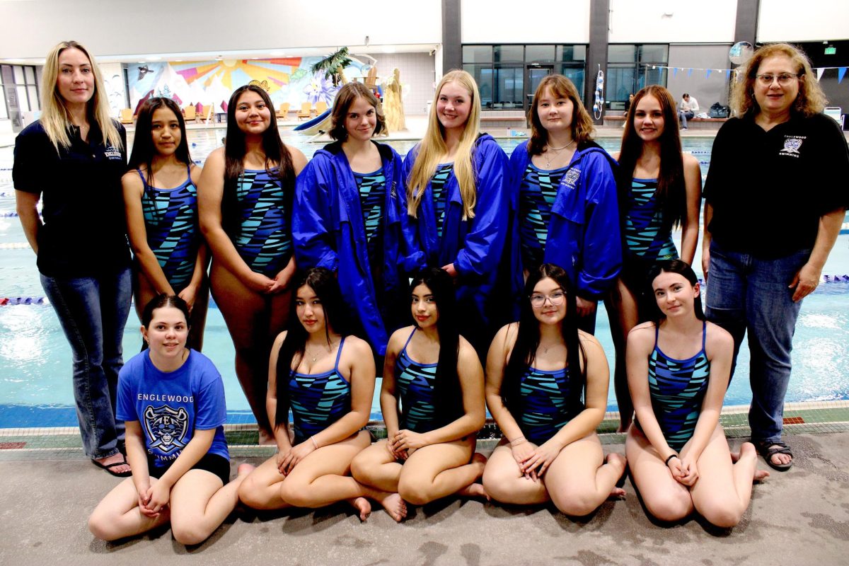 The Englewood swim team poses next to the pool while practicing for their upcoming competition, showing their school pride and team camaraderie.