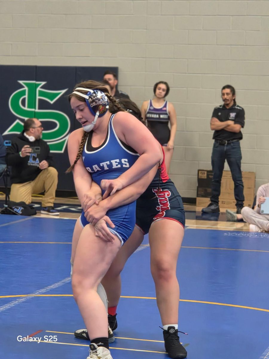 Maile Manfre holds off an opponent on the wrestling mat. Manfre recently won her 100th match. For Englewood High School girls' wrestling, it is groundbreaking. "It feels really good. I've been working for it since freshman year. I never thought I would actually make it, but I did."
