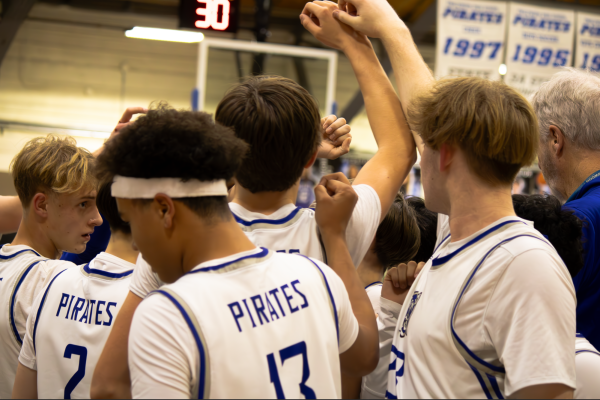 Englewood basketball team huddle ahead of one of the last games of the season. Right after this, the team headed to Aspen for playoffs.