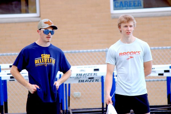 Madden Bain and Caleb Davis rest between sprints at a recent tarck practice.