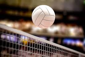 A volleyball travels over the net during a recent game. 